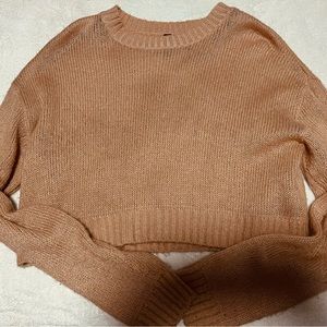 The color is baby pink, knit sweater top it’s a bit see through